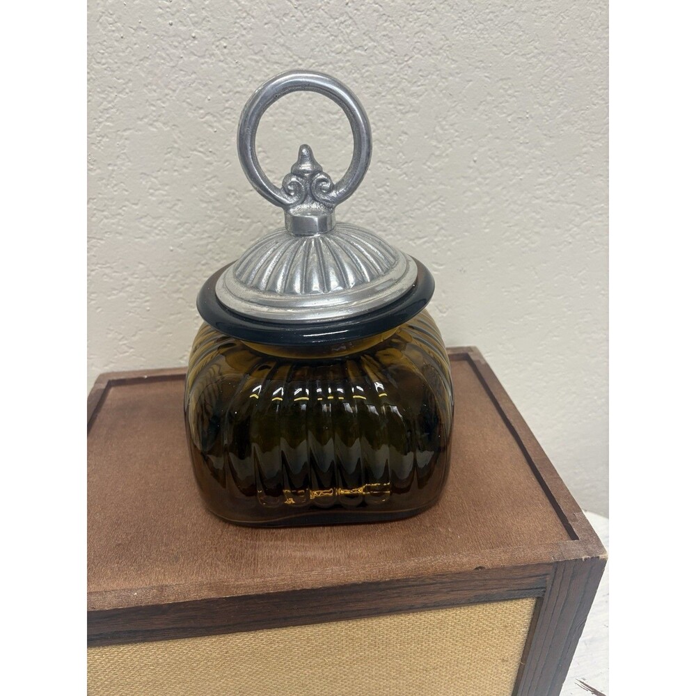Vintage amber ribbed glass apothecary canister with a pewter lid.  8.5" tall